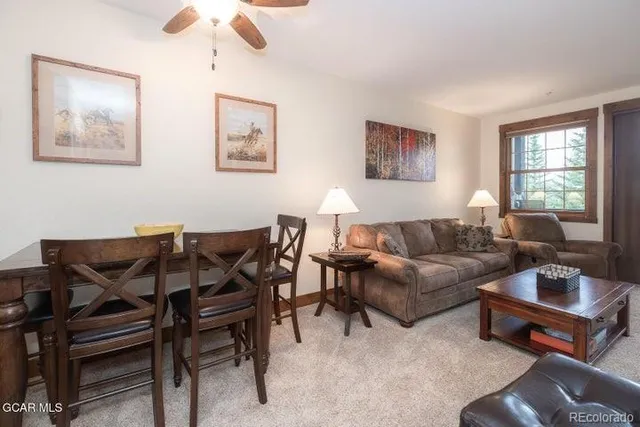 a living room with furniture a rug and a window