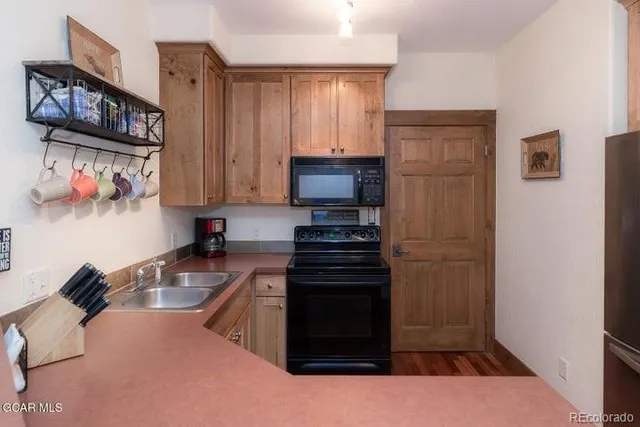a kitchen with a refrigerator and a sink