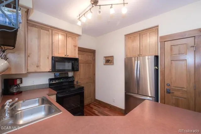 a kitchen with a refrigerator stove and sink