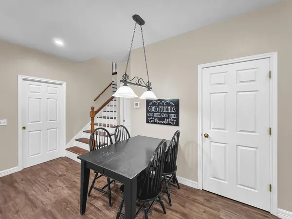 a view of a dining room with furniture wooden floor and chandelier