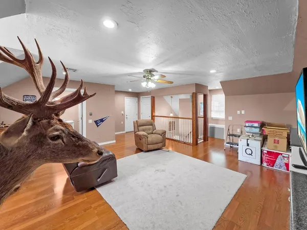 a living room with furniture and a chandelier