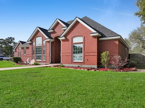 an aerial view of a house with a garden and swimming pool