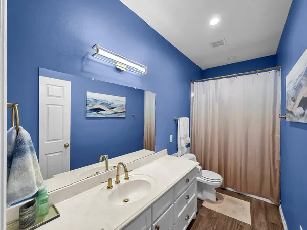 a bathroom with a sink vanity and a mirror