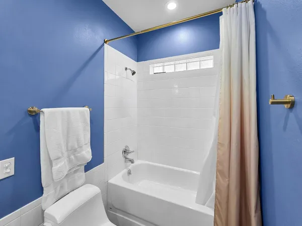 a bathroom with a bathtub and a toilet