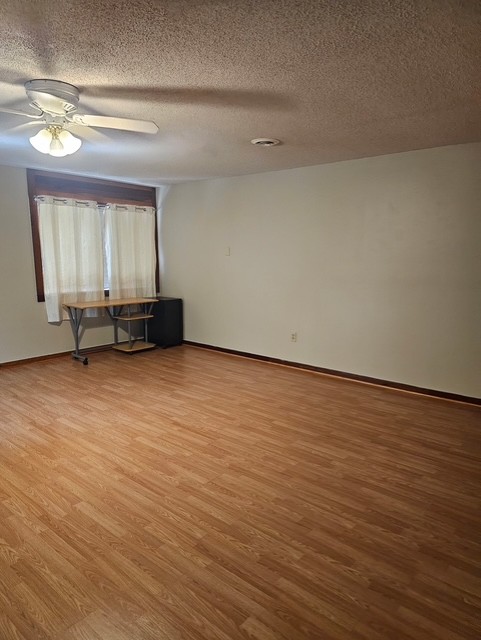 114 Houston Street Clemson, SC 29631 - Photo 16 of 19 Warm wood flooring defines this versatile room featuring classic textured ceilings and rich trim work.