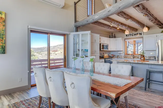 a kitchen with stainless steel appliances granite countertop a stove top oven a sink dishwasher and a refrigerator with wooden cabinets