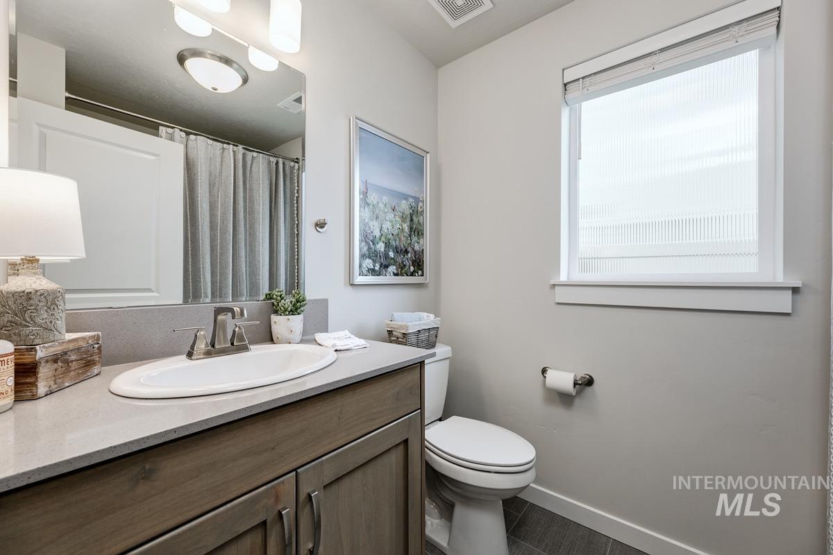 348 West Radiant Rdg Drive Meridian, ID 83642 - Photo 21 of 36 Vanity with a single basin sink, brushed nickel faucet, and integrated countertop