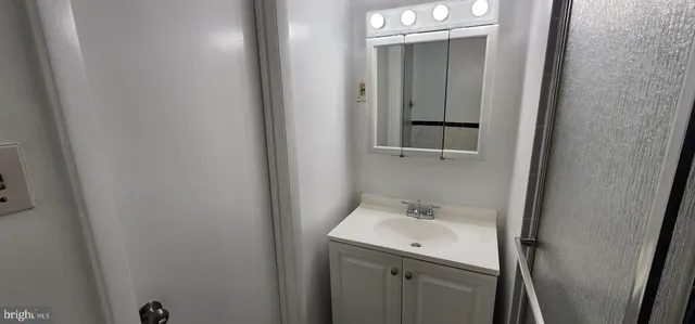 a bathroom with a sink and mirror