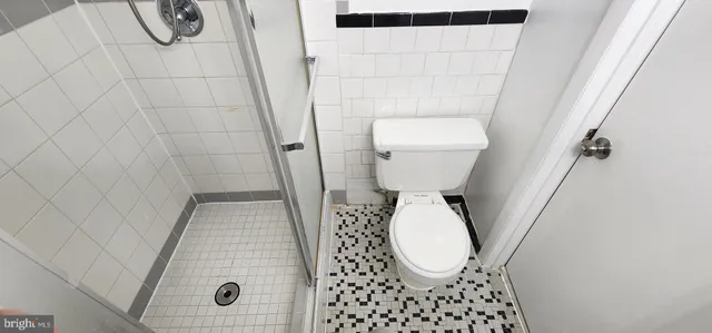 a bathroom with a toilet and a shower curtain