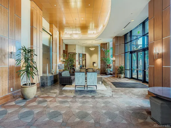 a lobby with furniture and a potted plant