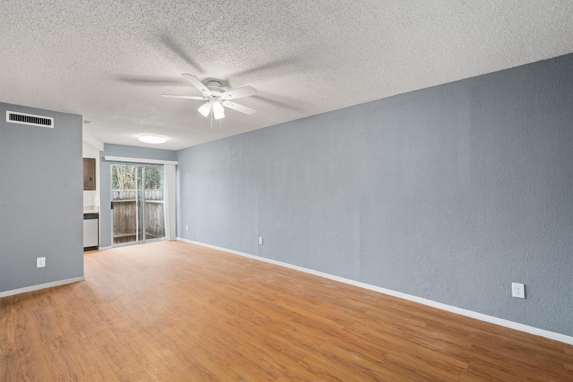 3415 Menchaca Road, Unit 107 Austin, TX 78704 - Photo 3 of 14 wooden floor in an empty room with a window