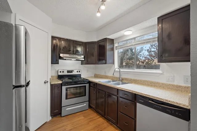 a kitchen with a sink appliances and cabinets