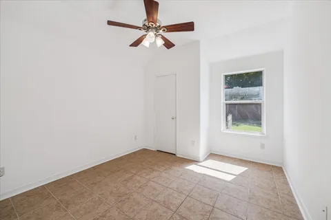 a bathroom with a granite countertop sink a toilet and a mirror