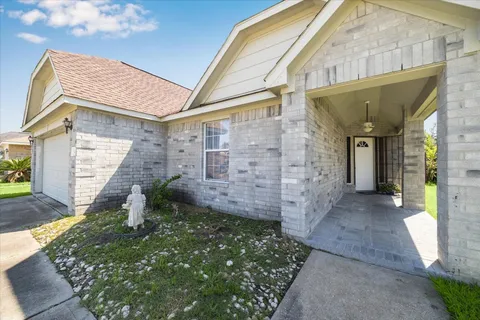a view of a brick house with a large windows