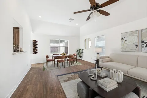 a living room with furniture and a wooden floor