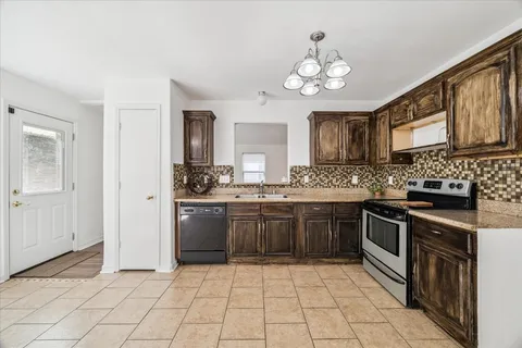 a kitchen with a stove top oven sink and cabinets