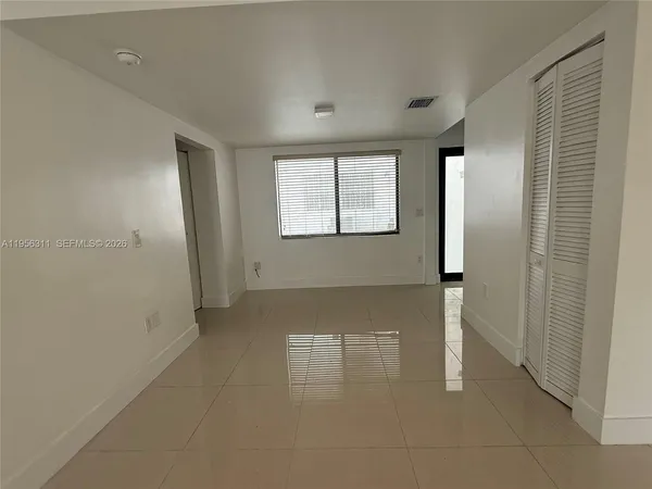 a view of an empty room with a window