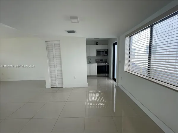 a view of kitchen with livingroom and window
