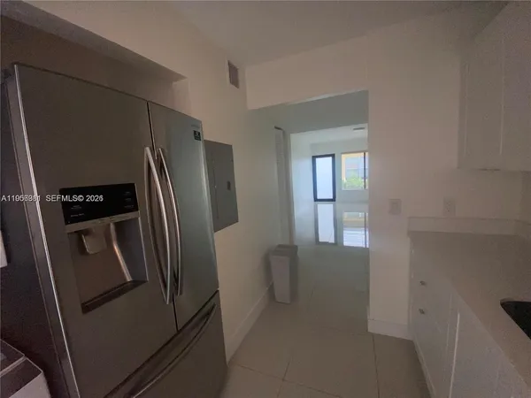 a view of a refrigerator in kitchen and a fridge