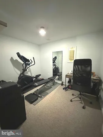 a room with gym equipment and a view of living room