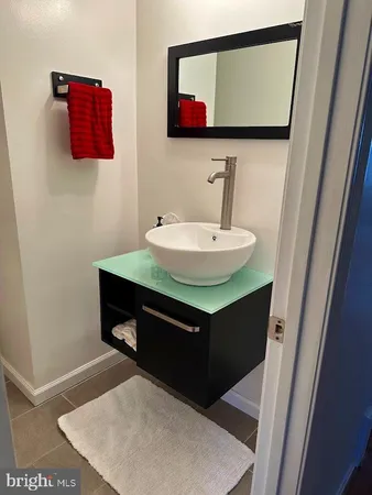 a room with a sink and a mirror