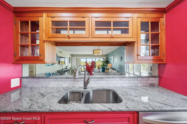 a view of a kitchen with granite countertop a stove and a sink
