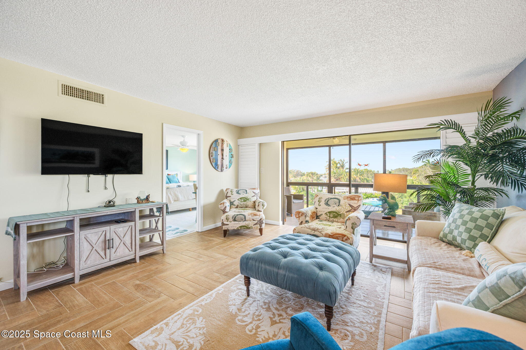 2001 South Banana River Boulevard, Unit 319 Cocoa Beach, FL 32931 - Photo 16 of 45 a living room with furniture and a flat screen tv