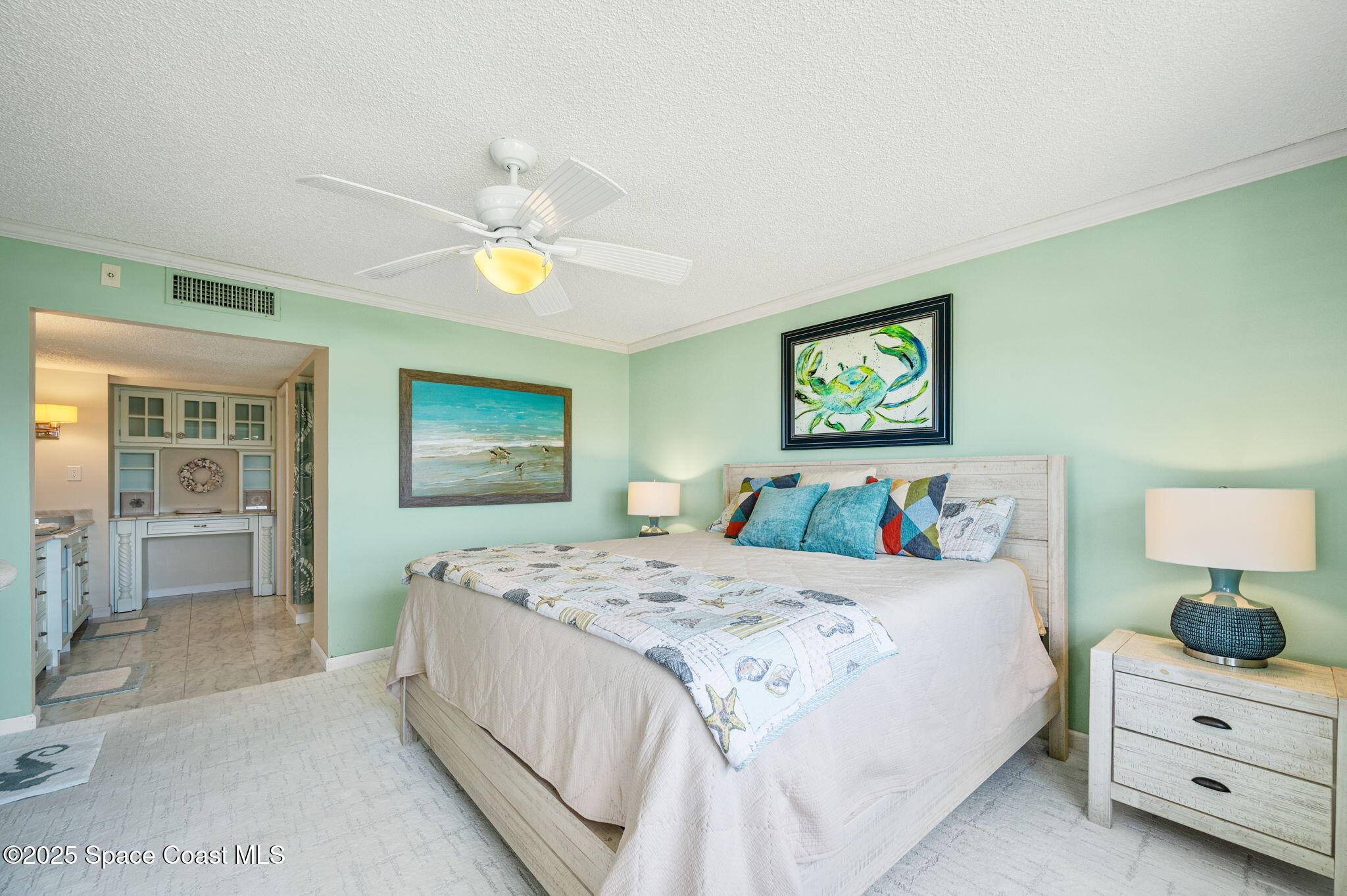 2001 South Banana River Boulevard, Unit 319 Cocoa Beach, FL 32931 - Photo 20 of 45 a bedroom with a bed and a chandelier