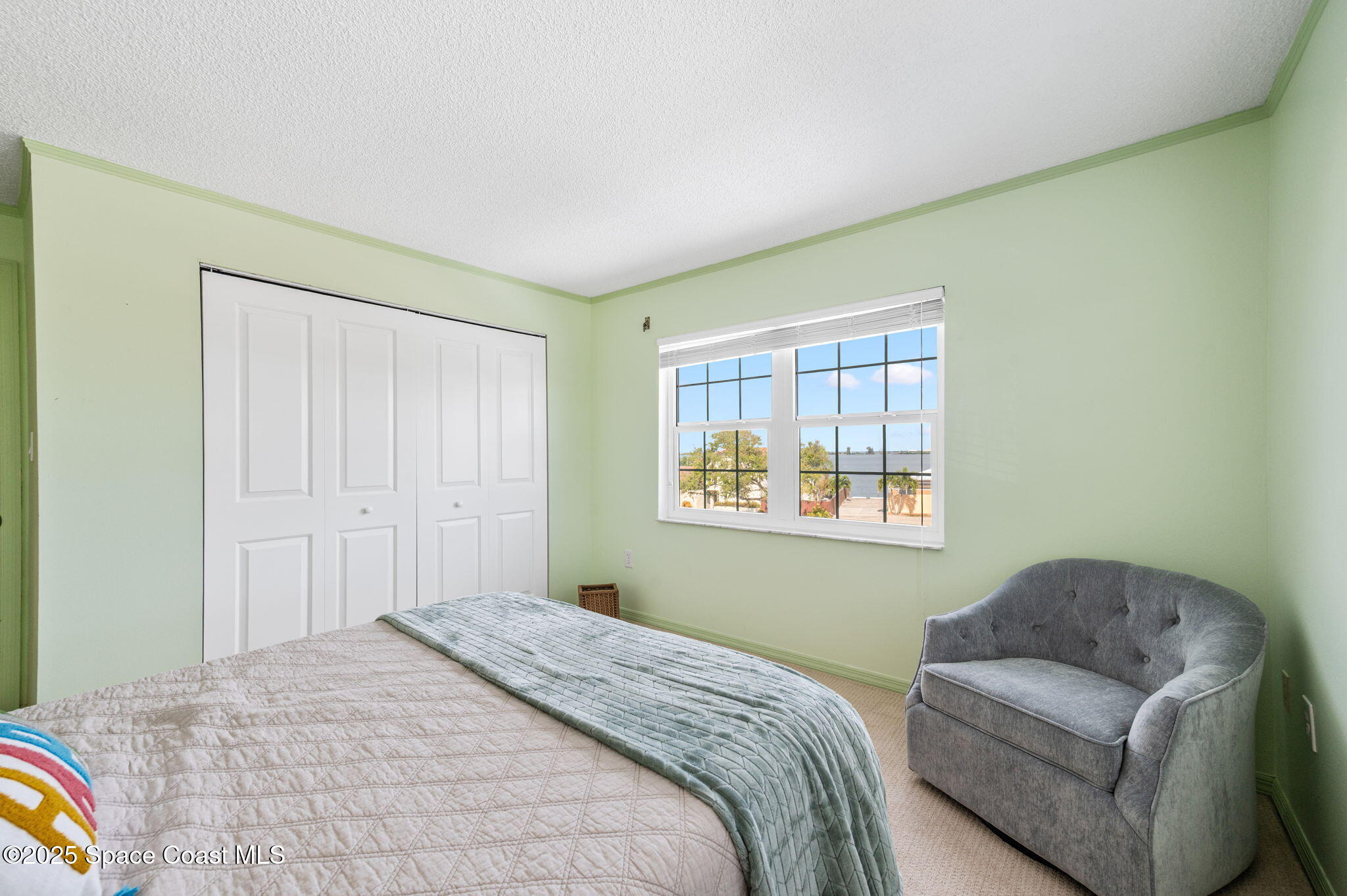 2001 South Banana River Boulevard, Unit 319 Cocoa Beach, FL 32931 - Photo 30 of 45 a bedroom with a bed and a couch