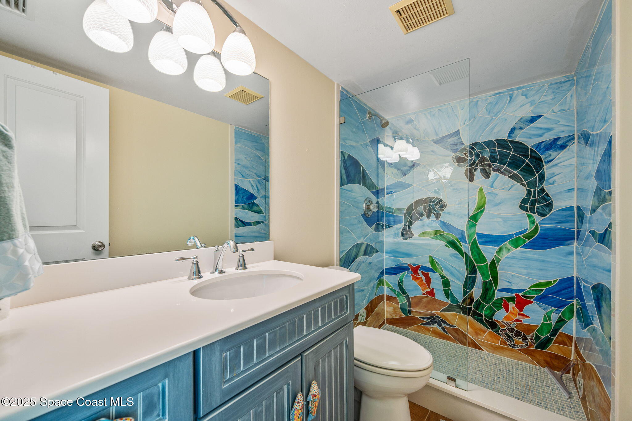 2001 South Banana River Boulevard, Unit 319 Cocoa Beach, FL 32931 - Photo 32 of 45 a bathroom with a sink a toilet and a mirror