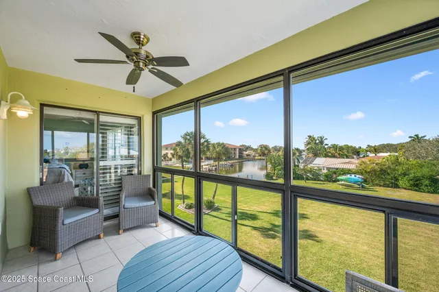 a view of a porch with furniture and a floor to ceiling window