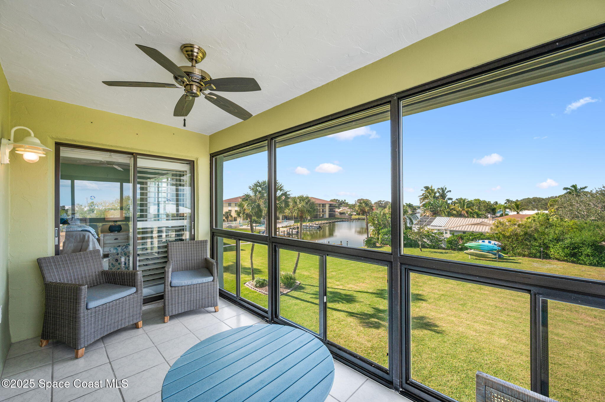 2001 South Banana River Boulevard, Unit 319 Cocoa Beach, FL 32931 - Photo 34 of 45 a view of a porch with furniture and a floor to ceiling window