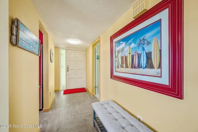 a view of a hallway with paintings on the wall