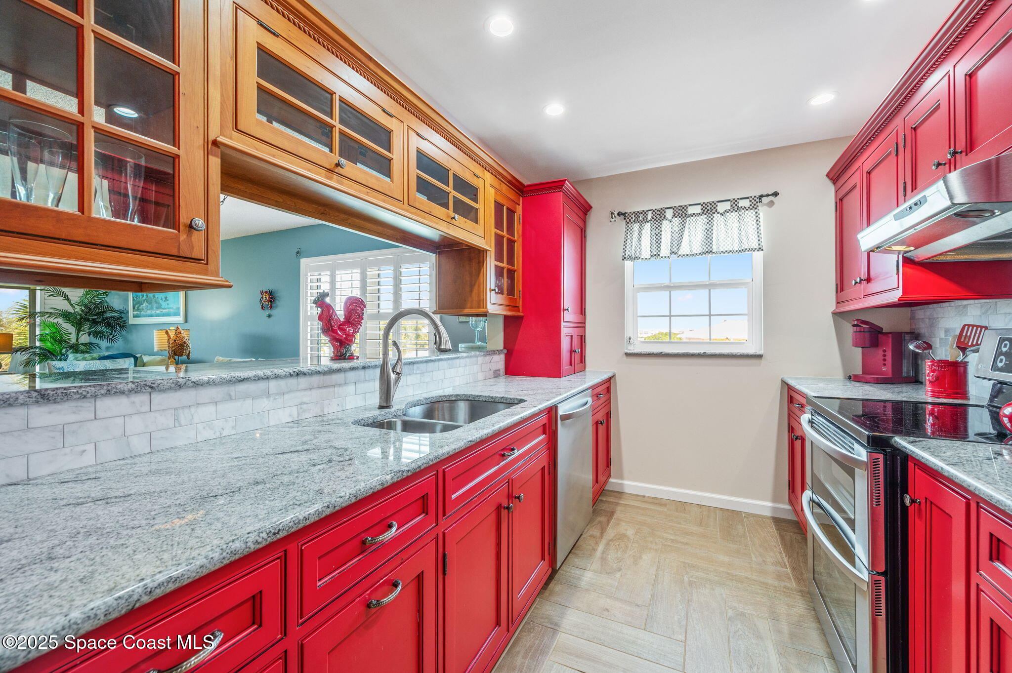 2001 South Banana River Boulevard, Unit 319 Cocoa Beach, FL 32931 - Photo 6 of 45 a kitchen with stainless steel appliances granite countertop a sink and dishwasher