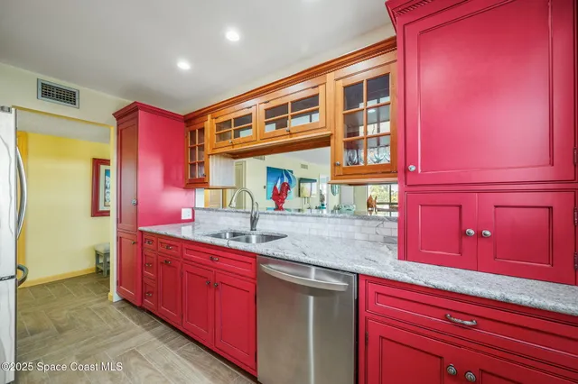 a kitchen with stainless steel appliances granite countertop a sink and cabinets