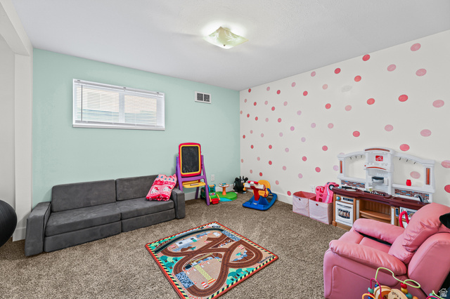822 Pinewood Circle Price, UT 84501 - Photo 29 of 49 Carpeted room featuring a window with horizontal blinds, light blue painted walls, and a white wall with red and pink polka dot accents