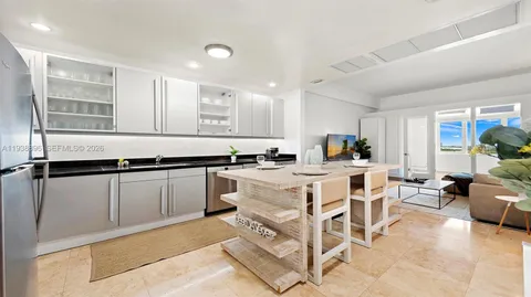 a living room with furniture a window and kitchen view