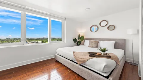 a bedroom with a bed and window