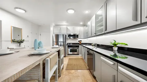 a kitchen with stainless steel appliances a sink stove and cabinets