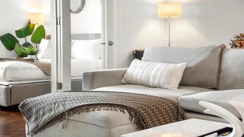 a living room with a bed furniture and a lamp