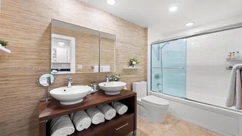 a bathroom with a toilet a sink and shower