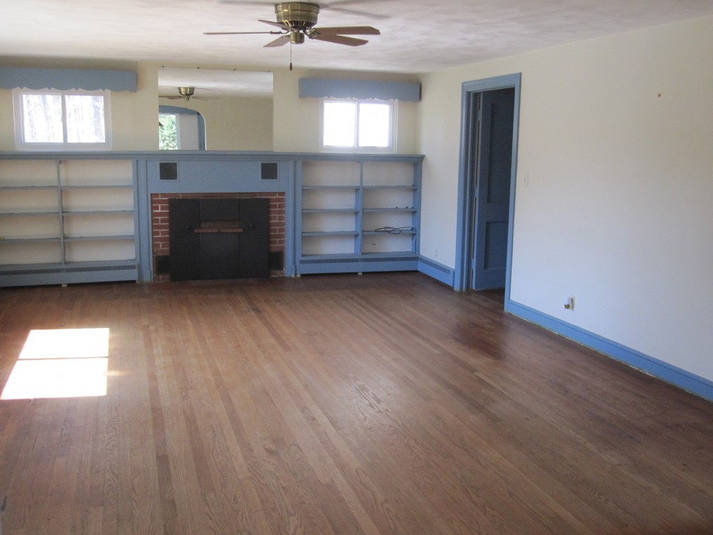 51 Scantic Road Hampden, MA 01036 - Photo 3 of 11 wooden floor fireplace and windows in an empty room
