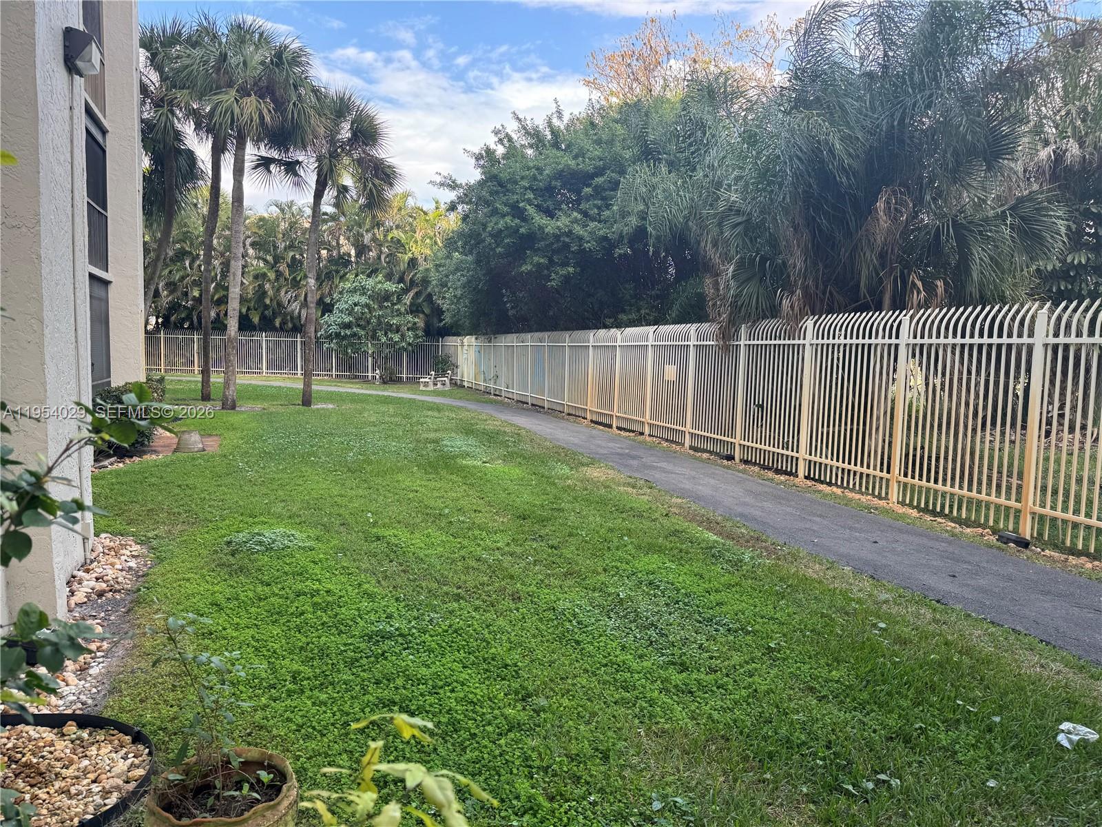 3940 Inverrary Boulevard, Unit 106A Lauderhill, FL 33319 - Photo 16 of 19 a view of a backyard with plants and trees