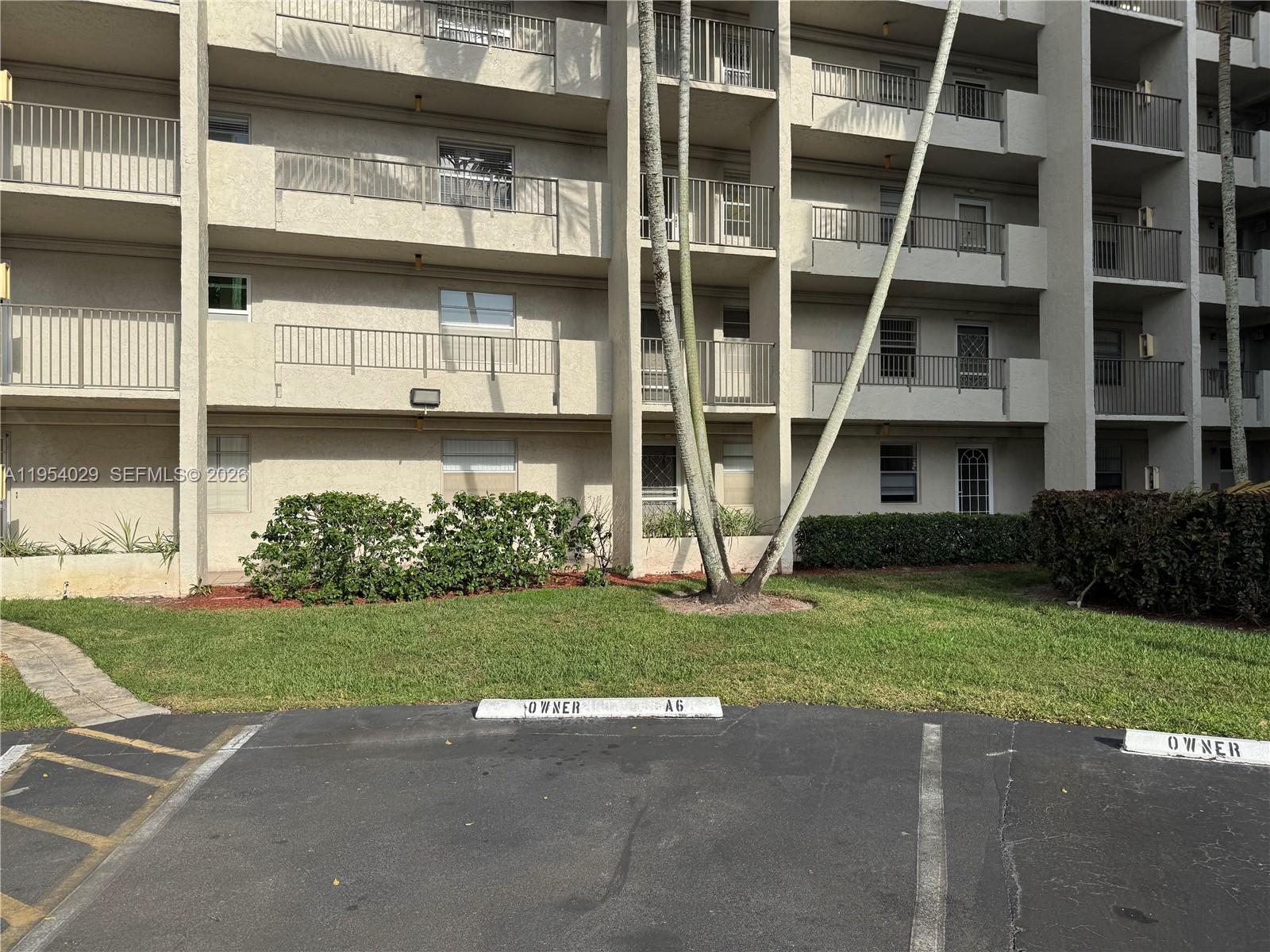 3940 Inverrary Boulevard, Unit 106A Lauderhill, FL 33319 - Photo 2 of 19 a front view of a building with a yard