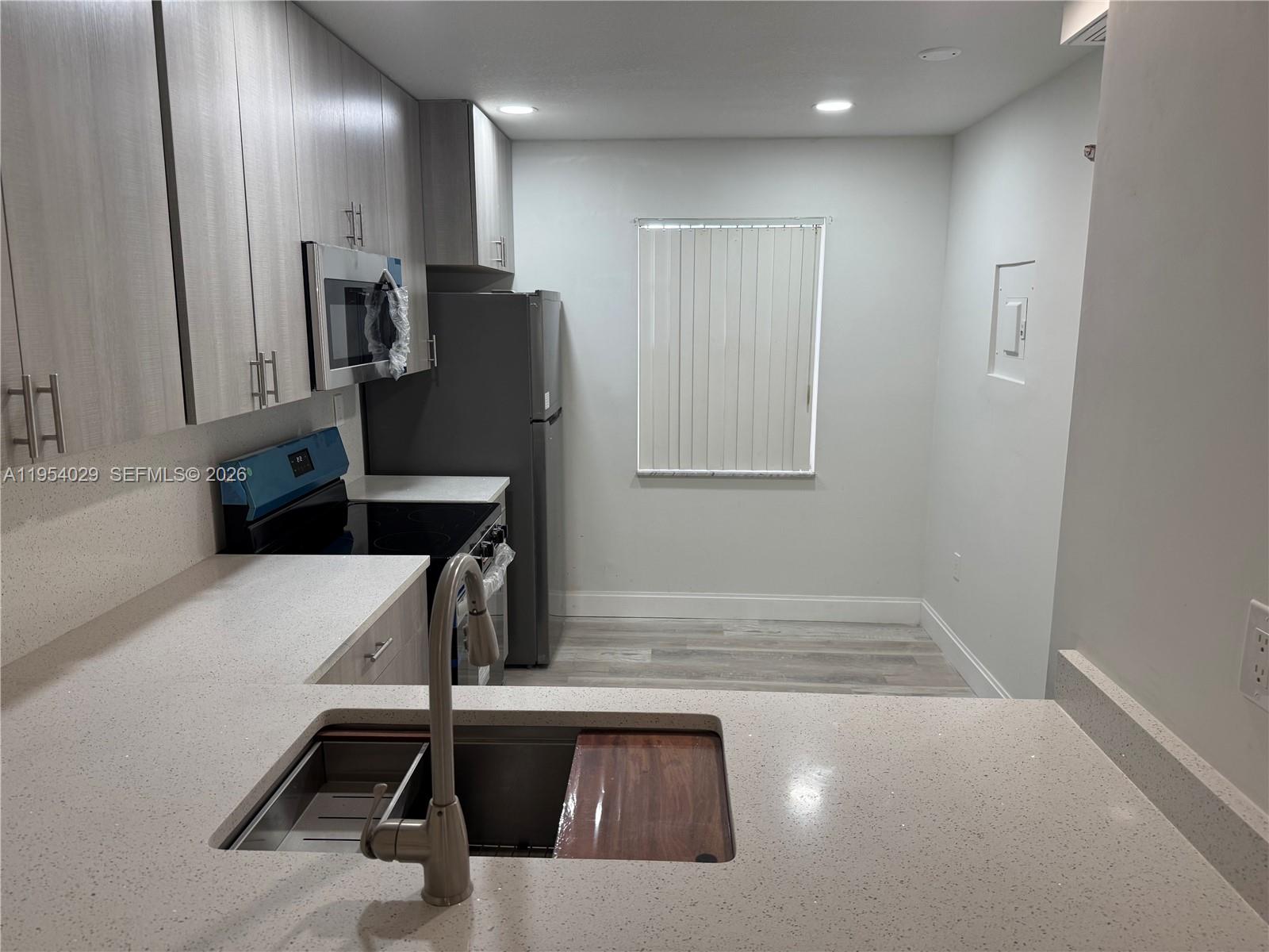 3940 Inverrary Boulevard, Unit 106A Lauderhill, FL 33319 - Photo 3 of 19 a view of a kitchen with a sink and a refrigerator