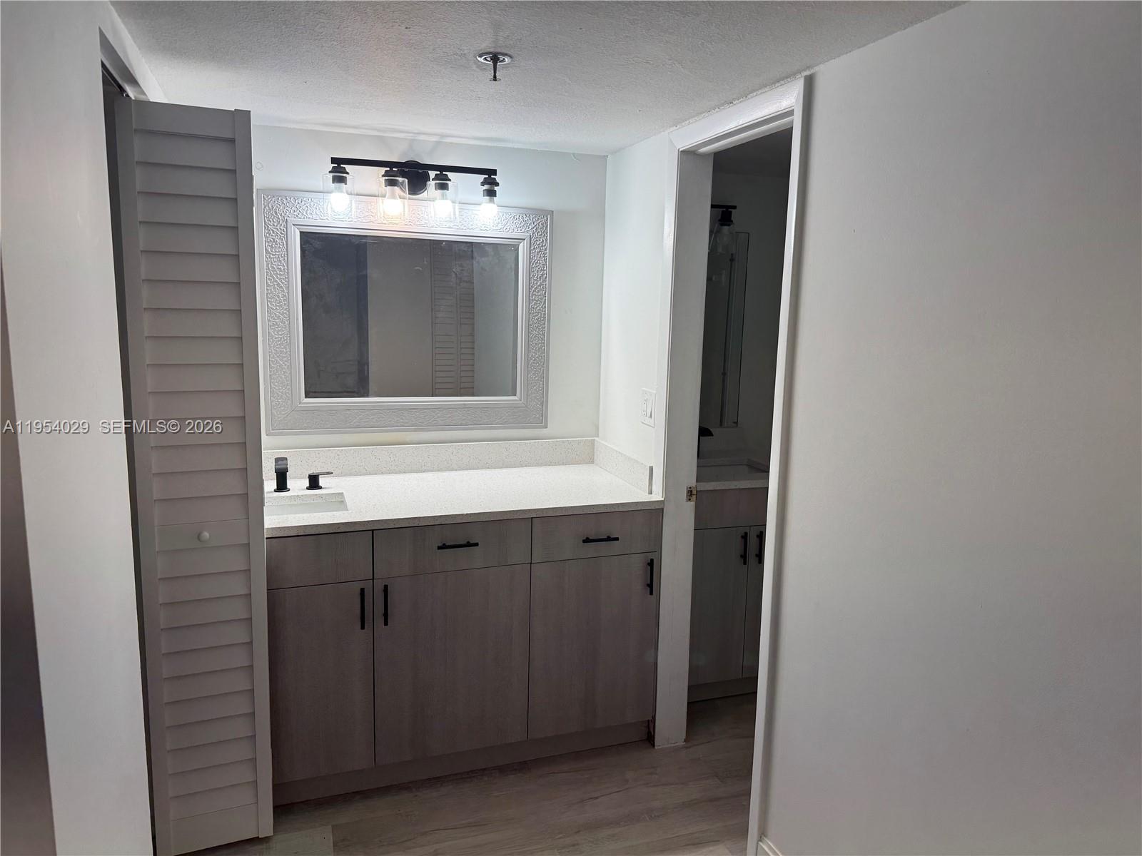 3940 Inverrary Boulevard, Unit 106A Lauderhill, FL 33319 - Photo 7 of 19 a bathroom with a sink and mirror