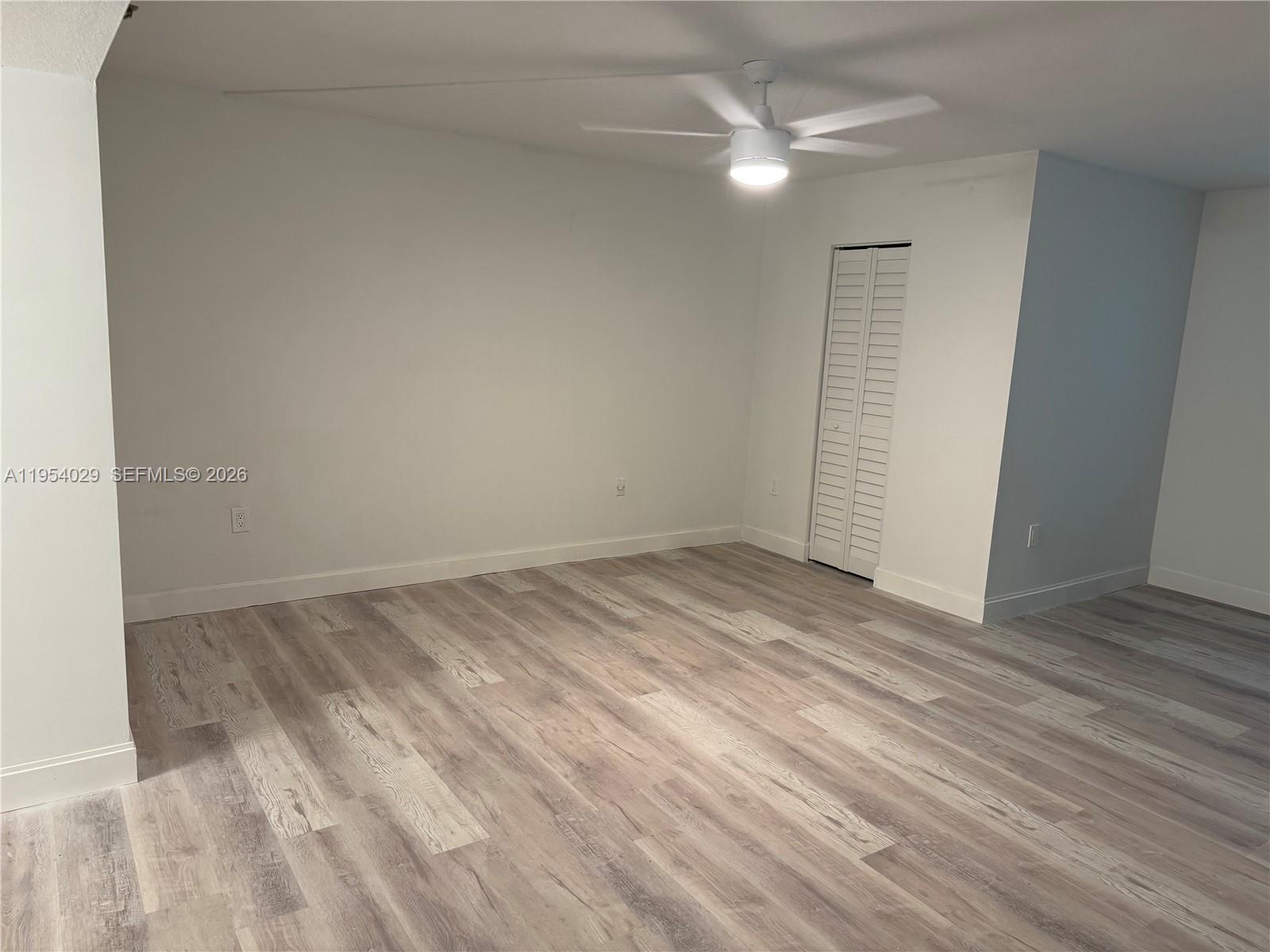 3940 Inverrary Boulevard, Unit 106A Lauderhill, FL 33319 - Photo 9 of 19 an empty room with a ceiling fan and carpet