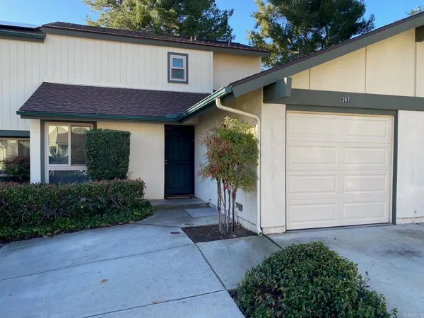a view of a house with a yard and plants