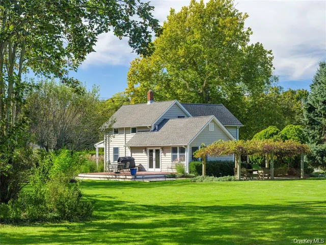a front view of a house with swimming pool having outdoor seating