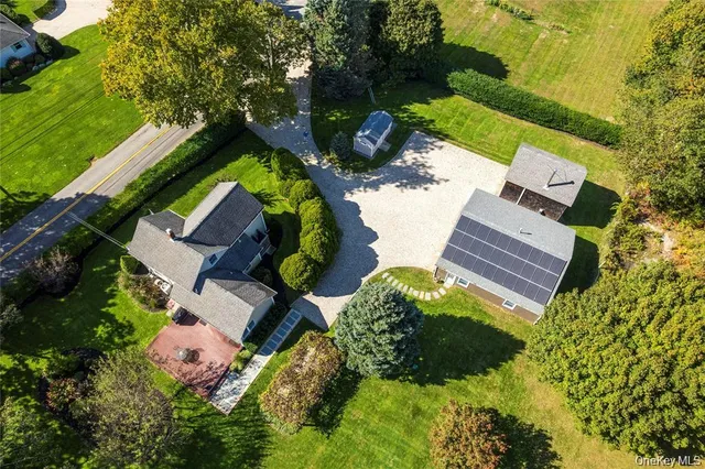an aerial view of house with yard swimming pool and outdoor seating